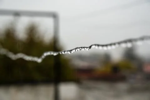 Clothesline wire full of small drops on a rainy day with a selective focus Foto stock