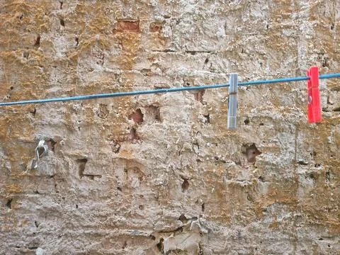 Clothesline on worn wall Stock Photos