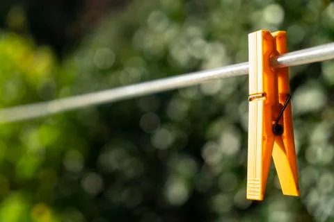 Clothespin hanging on a wire Stock Photos