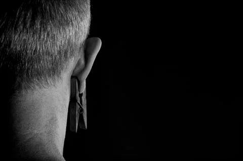 Clothespin on a man's ear. Stock Photos