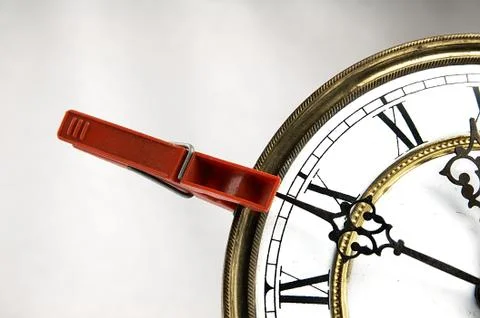 Clothespin stop the clock. Stock Photos