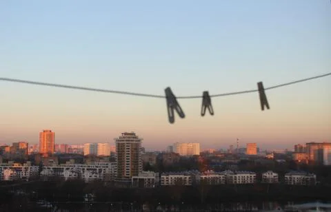 Clothespins on the background of the city. Stock Photos