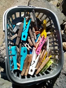 Clothespins in basket Stock Photos