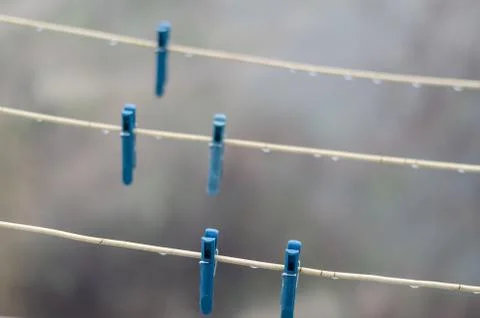 Clothespins on empty clothesline. Stock Photos