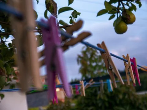 Clothespins hanging from a string Stock Photos