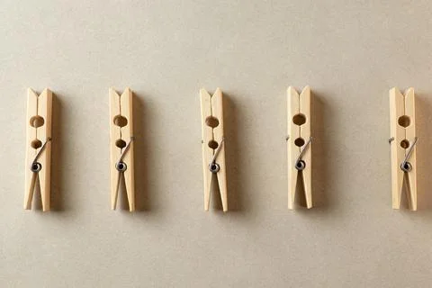 Clothespins on a neutral background highlight simplicity and function Stock Photos