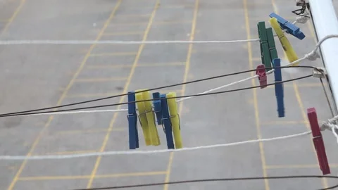 Clothespins on a rope swing in the wind. Stock Footage 169999758