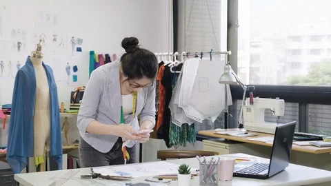 Clothing designer photographing sewing patterns Stock Footage 111312349