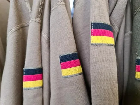 Clothing with German colors flag patch hanging on display Fotos de archivo
