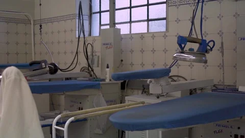 Clothing Iron hanging on a empty working fatory Stock Footage 128785338