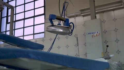 Clothing Iron hanging on a empty working factory 2 Stock Footage 128785374