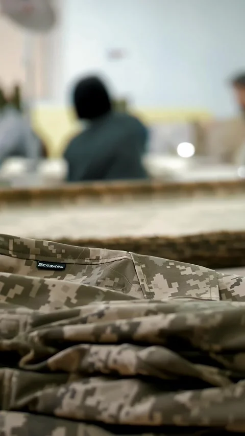 Clothing quality check. close-up. sewing of camouflage military clothes. Working Stock Footage 316466860