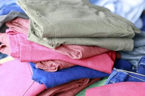 Clothing stack, colorful folded clothes showing fabric texture, folds, and .. Stock Photos