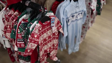 A clothing store featuring a festive collection of holiday-themed children's out Stock Footage 295673728