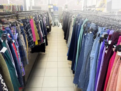 Clothing store, second hand. Rows of clothes on hangers Stock Photos
