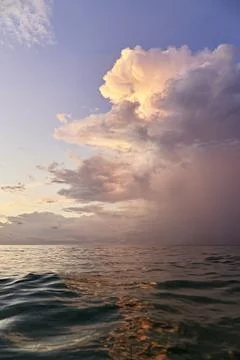 The cloud above the sea surface is red from sunset Stock Photos