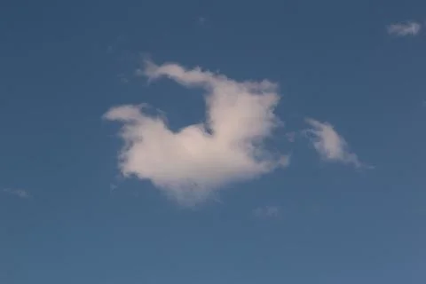 A cloud against a blue sky Stock Photos