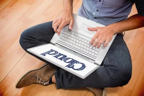 Cloud against young creative businessman working on laptop Illustrazione stock