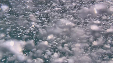 Cloud of air bubbles drifts underwater through seawater creating gentle movement 스톡 동영상 335076812