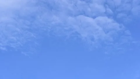 Cloud and blue sky timelape of dramatic fast moving white clouds on sunny blue Stock Footage 198043775
