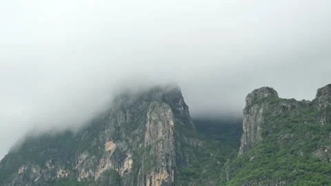 Cloud and fog cover limestone mountain in the rainy season Stock Footage 141503765