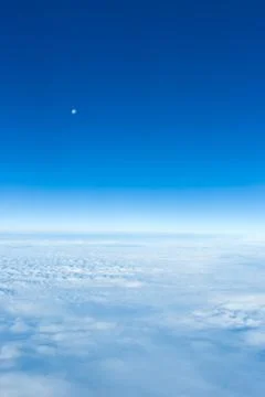 Cloud and sky with moon as seen through window of airplane Stock-Fotos