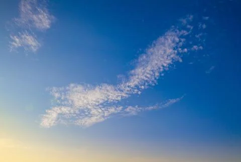 Cloud on background of blue sky, yellow dawn with highlights from sun Foto stock