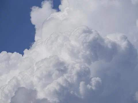 Cloud background. A large soft white cumulonimbus cloud against a blue sky Stock Photos
