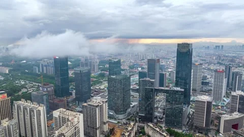 Cloud bands crossing Wanbo office towers timelapse in Guangzhou China Stockbeeldmateriaal 345956656
