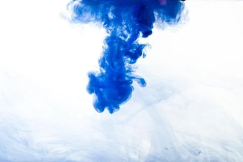 A cloud of blue paint released into clear water. Isolate on a white backgroun Stock Photos