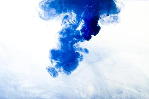 A cloud of blue paint released into clear water. Isolate on a white backgroun 写真素材