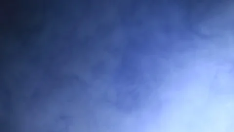 Cloud of Blue Smoke Dissipates Over Dark Background Stock Footage 100575986