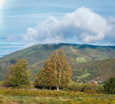A cloud brushes the summit of a mountain Stock Photos