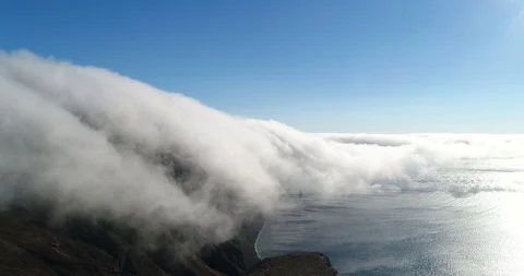 Cloud cascade over island Stock Footage 128700733