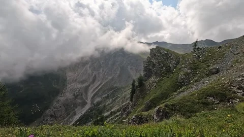 Cloud clearing over scree slopes and alpine meadow, Colle della Gianna, Monviso Stock Footage 344537026