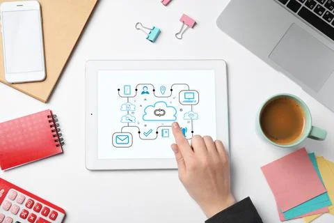 Cloud computing and storage concept. Woman using tablet at white table, top v Stock Photos