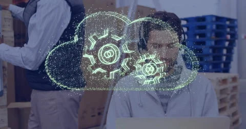 Cloud computing animation over person working on laptop in office setting Stock Footage 304075890