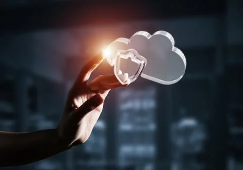 Cloud computing concept with glass symbol shown in hand. Mixed m Stock Photos