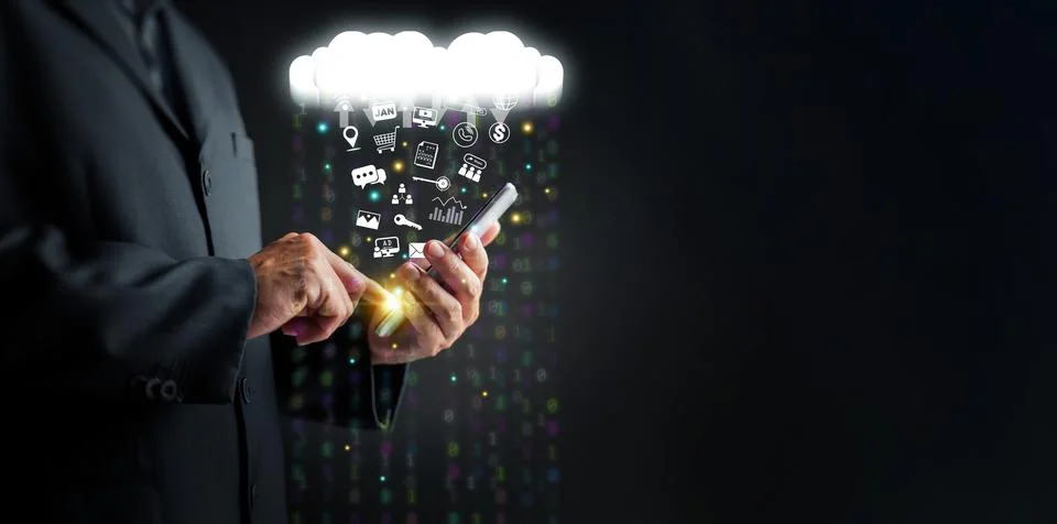 Cloud Computing Concept  A man uses a smartphone to upload and download IT .. Stock Photos