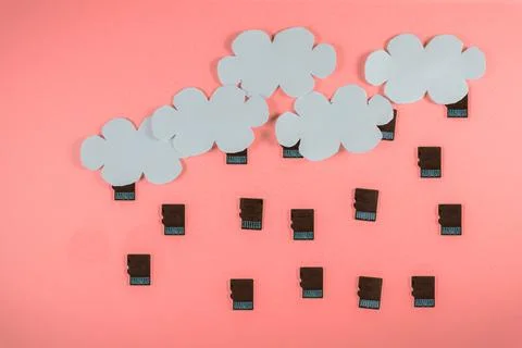 Cloud computing concept, paper clouds with micro SD cards as raindrops Stock Photos