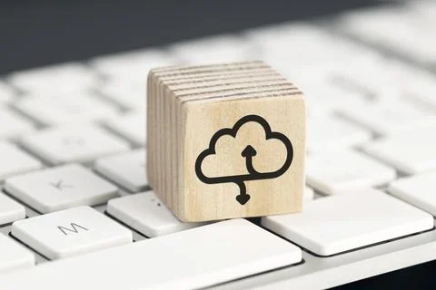 Cloud computing icon on wooden block on computer keyboard Stock Photos