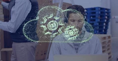 Cloud computing image over person working on laptop in office setting Stock-Fotos