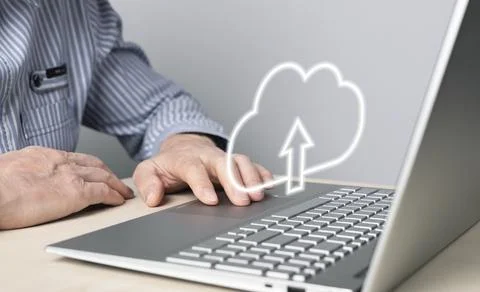 Cloud computing. Man using laptop for files upload, storage or sharing online Foto stock
