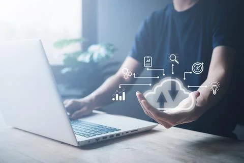 Cloud computing technology on hand of businessman. Man is using notebook (L.. Stock Photos