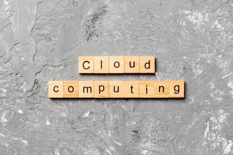Cloud computing word written on wood block. Cloud computing text on cement ta Stock Photos