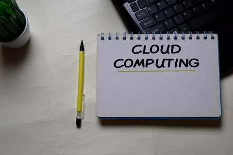 Cloud Computing write on a book isolated on office desk. Stock Photos