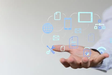 A cloud connected to many objects on a virtual screen. Stock Photos