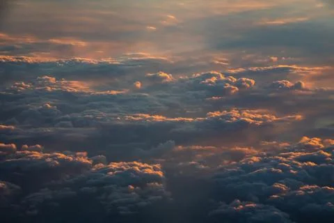Cloud cover shining red and orange because of setting sun Stock Photos