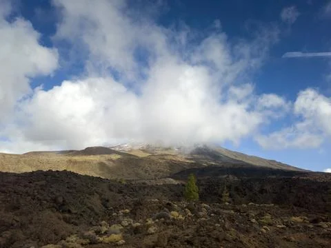 Cloud Covered Volcano Landscape Under Blue Sky 스톡 사진