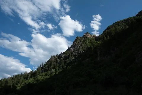 Cloud darkens the steep slope of Mt Timpanogos, Provo, Utah Stock Photos